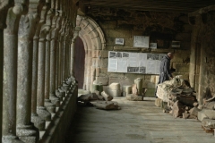 Un moine passe sous la galerie ouest de l'abbaye